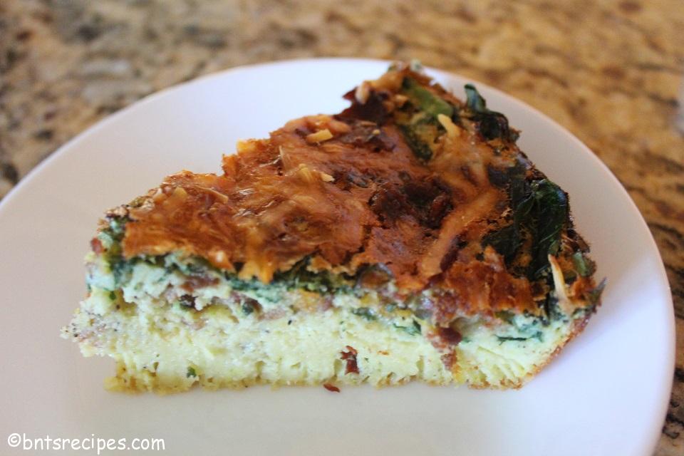 slice of crustless bacon and spinach quiche with cheese