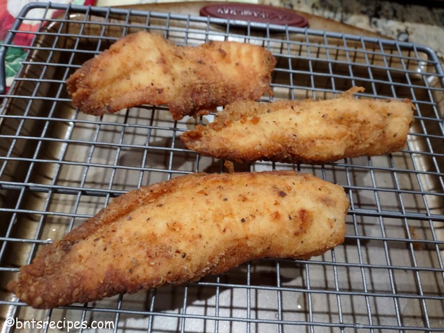 crispy fried tilapia on a wire rack