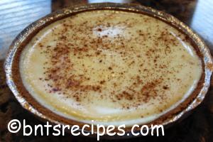 whole classic cheesecake with cinnamon dusting
