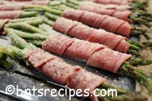 turkey bacon-wrapped asparagus with parmesan dusted before baking