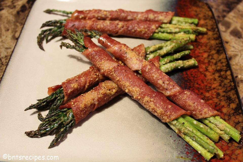 aerial view of baked turkey bacon-wrapped asparagus with parmesan