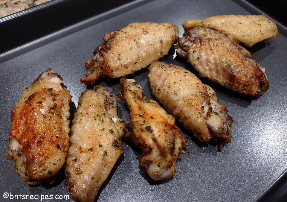 close-up of baked beer-brined ranch chicken wings on metal tray