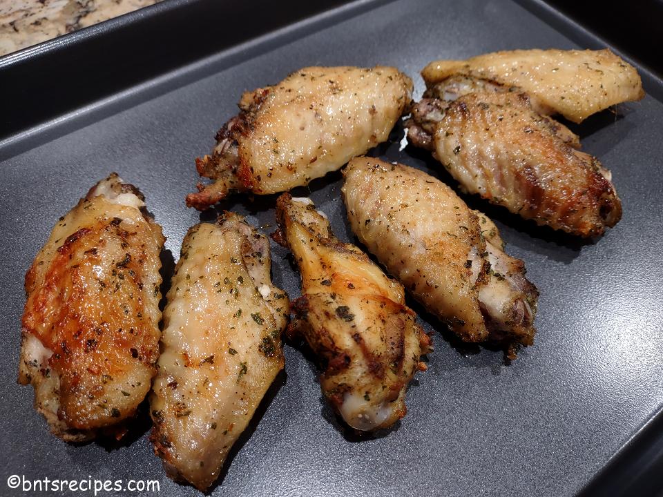 close-up of baked beer-brined ranch chicken wings on metal tray