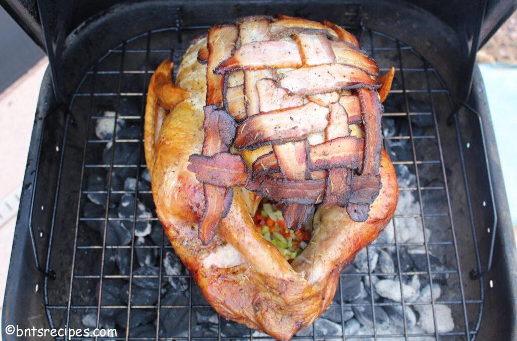 brined and barbequed whole turkey with bacon vest