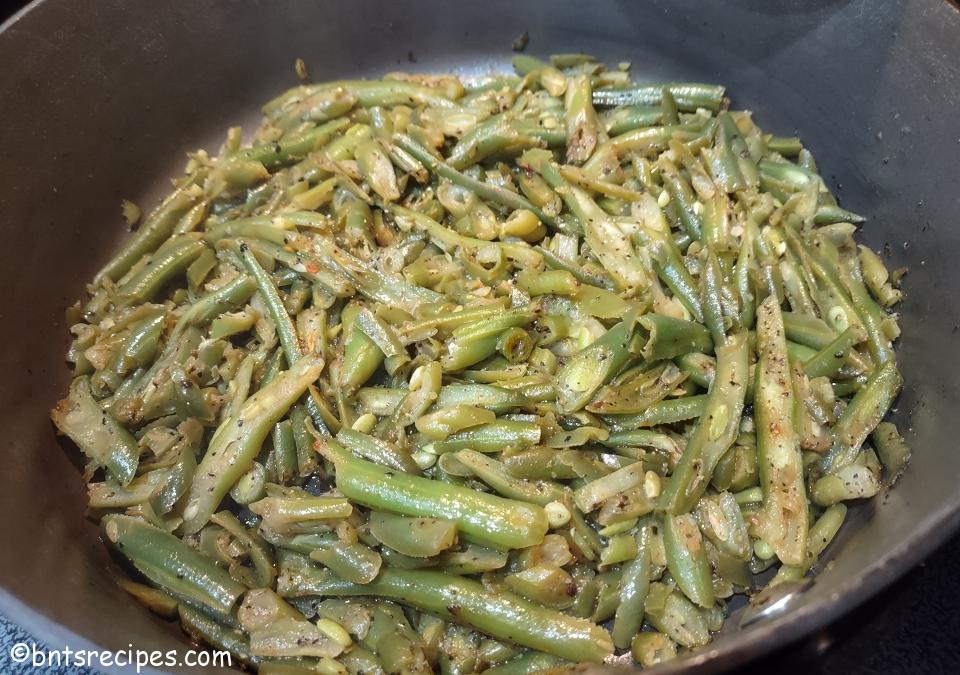 close-up of frozen french style green beans sauteed in a pan