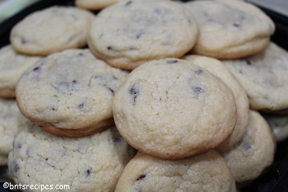 close-up of chewy chocolate chip cookies in a black container