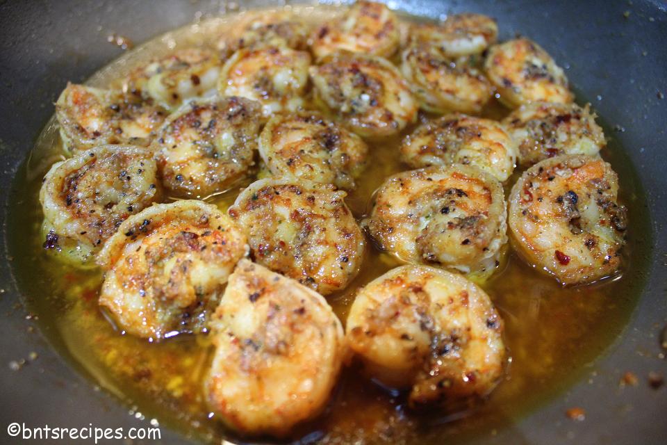 close-up of sauteed shrimp in garlic butter sauce in pan