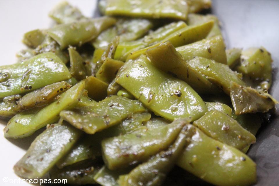 close-up view of sauteed italian green beans in a black and white abstract bamboo bowl