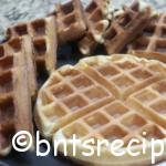 close-up view of fluffy buttermilk waffles on black and white abstract bamboo plate