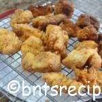 aerial view of crispy dark and golden brown pan fried cod nuggets on wire rack