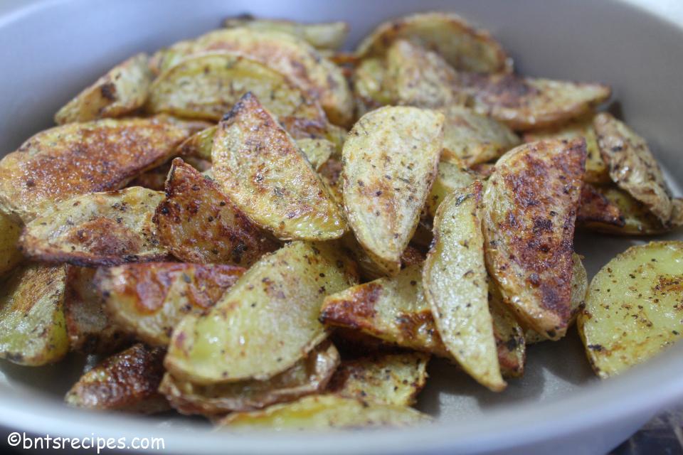 close-up view of oven baked potato wedges in silver cake pan
